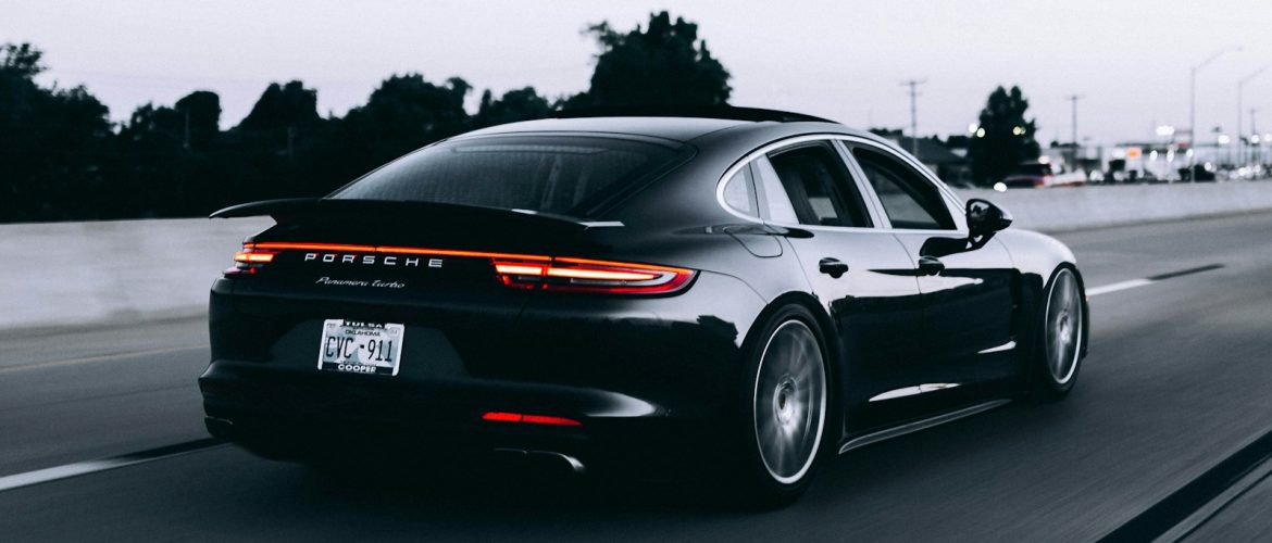 running black Porsche sedan