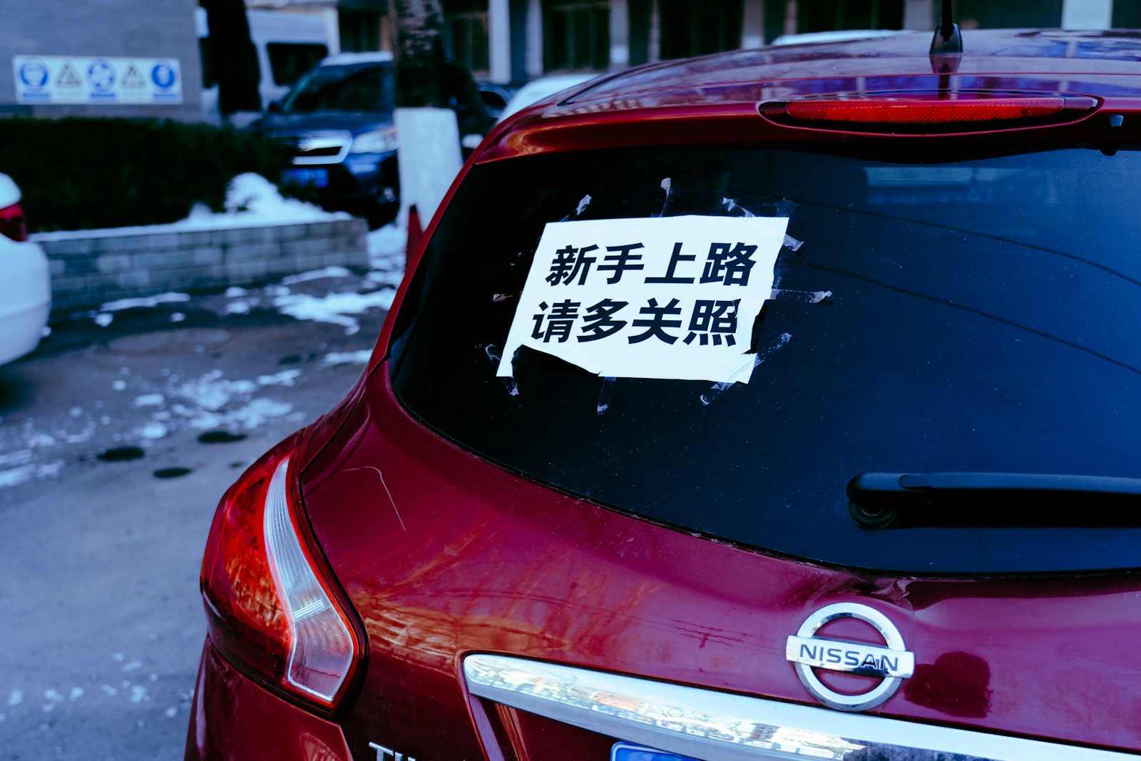 a car parked on the side of the road with a sticker on it